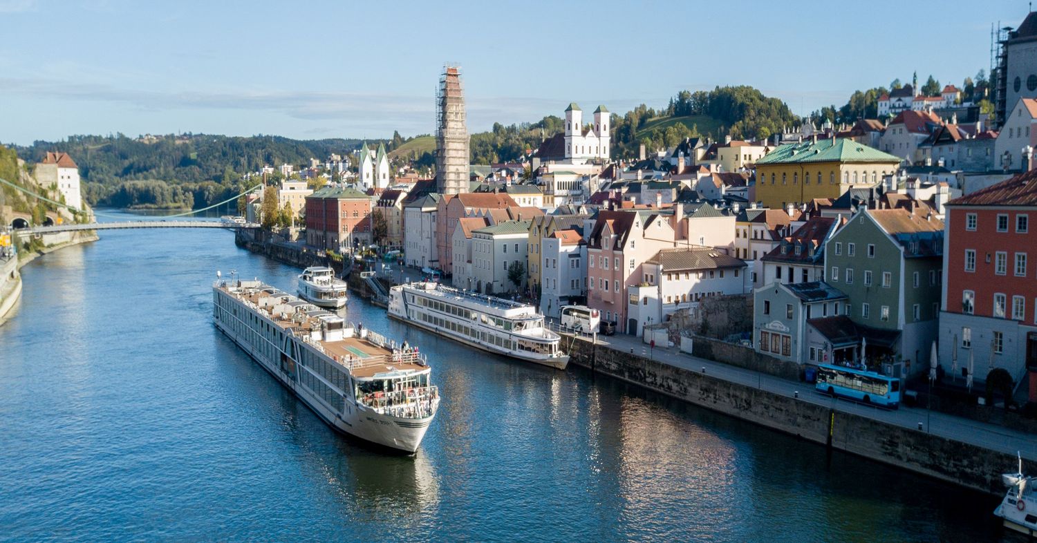 European river cruise ship passing a waterfront town